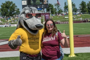 mascot and woman giving thumbs up