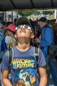 boy watching eclipse through view finders