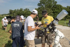 group of guys setting up telescope